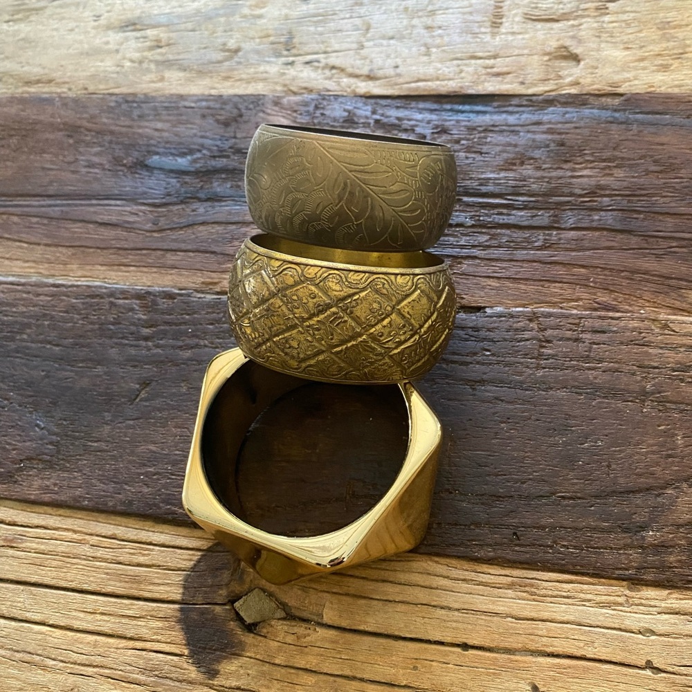 3 gold and brass bracelets